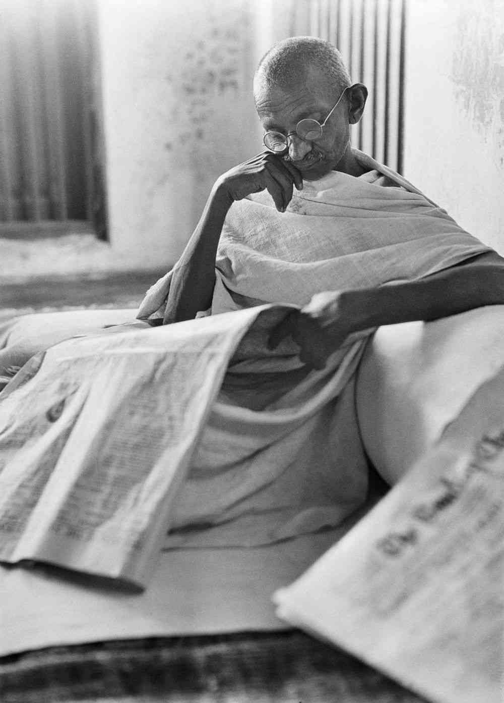Mahatma Gandhi reading newspaper