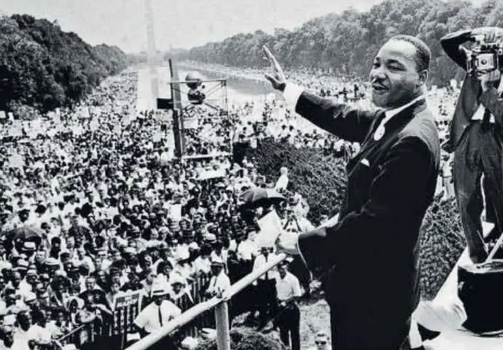 Martin Luther King, Jr. and wife Coretta Scott King lay a wreath at Rajghat during a visit to India in 1959.