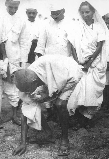 Mahatma Gandhi collecting salt granules at Bhimrad on the Gujarat coast on April 9, 1930.